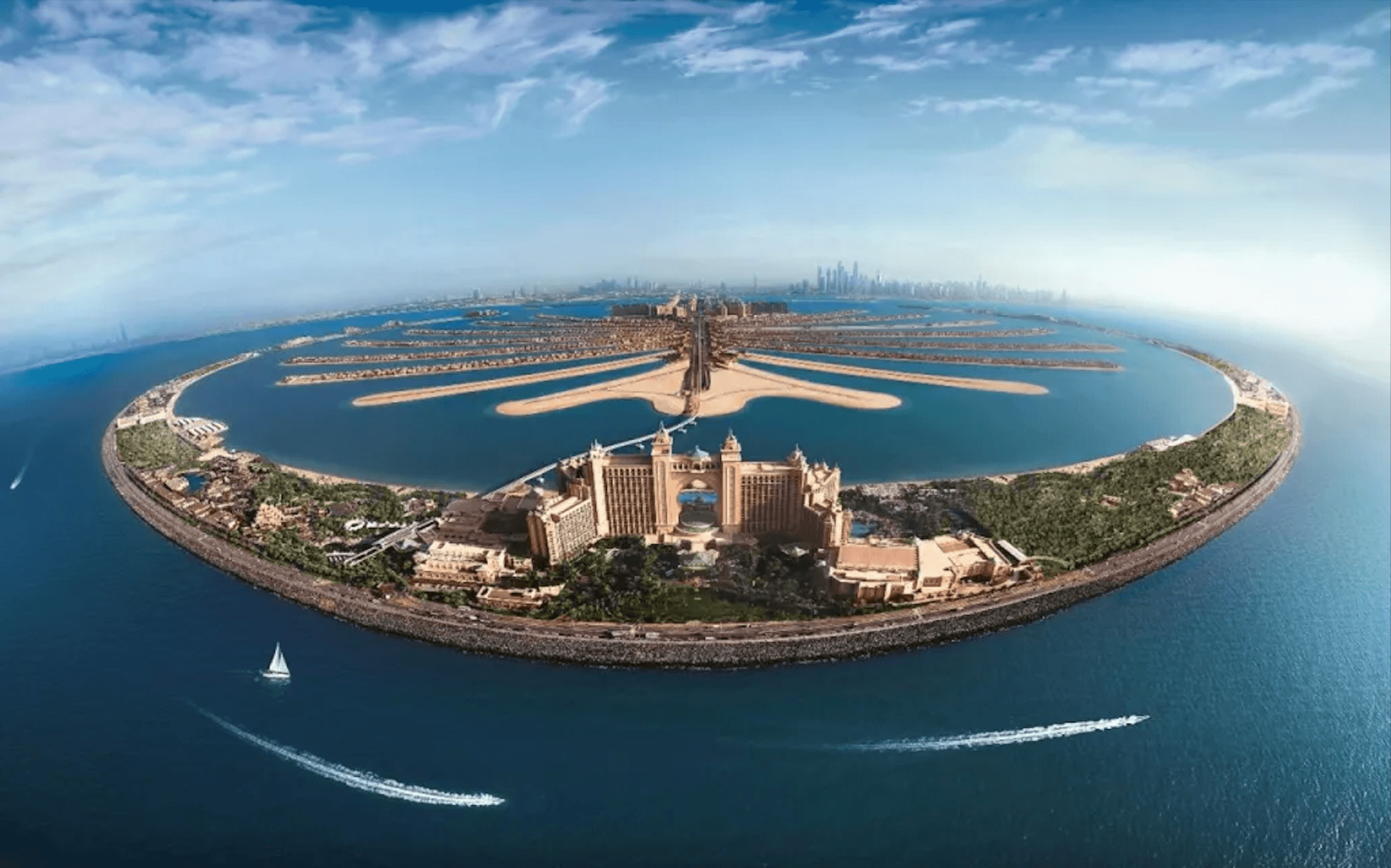 Aerial sunset view of Palm Jumeirah showing its iconic palm-shaped coastline