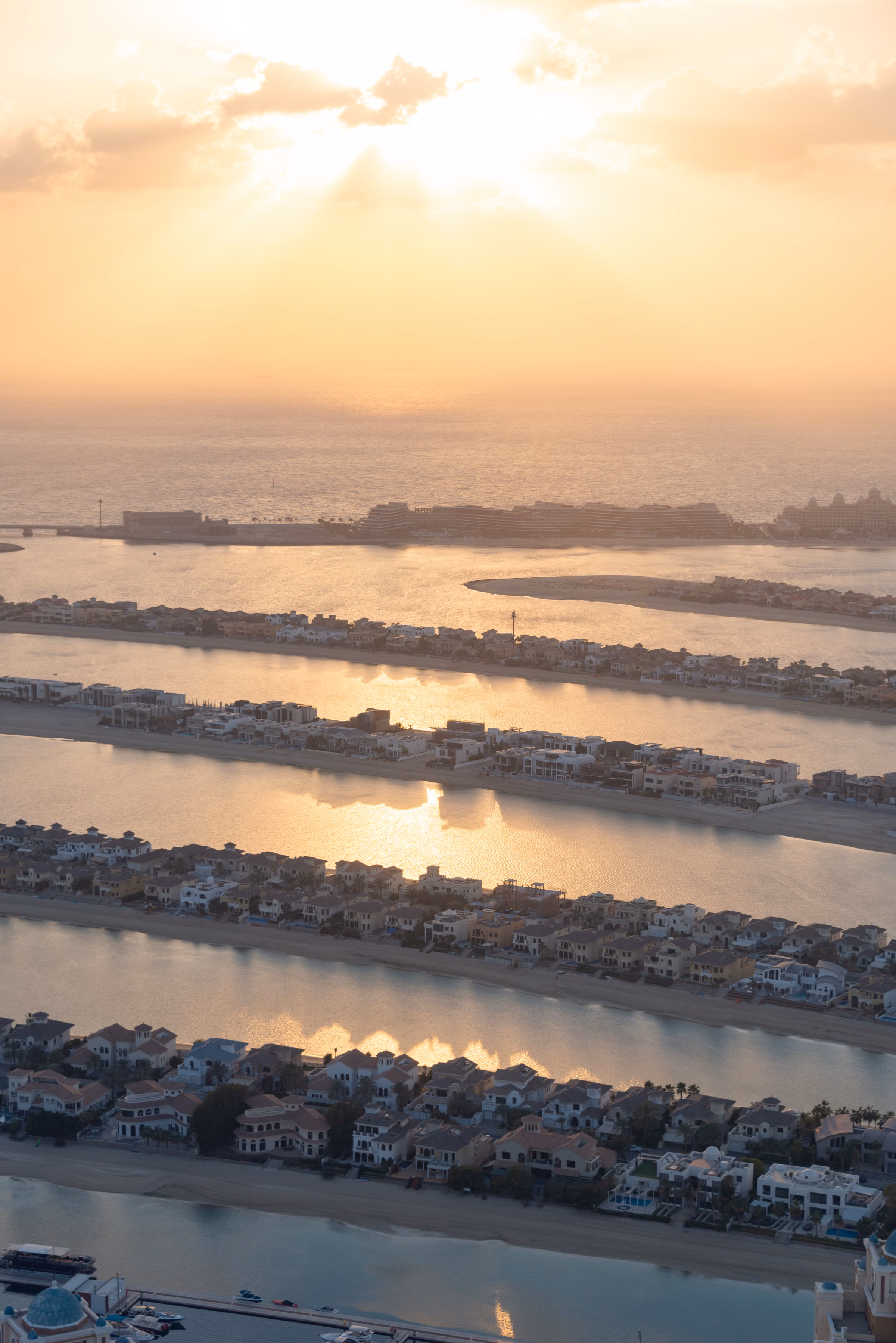 Aerial sunset view of Palm Jumeirah showing its iconic palm-shaped coastline