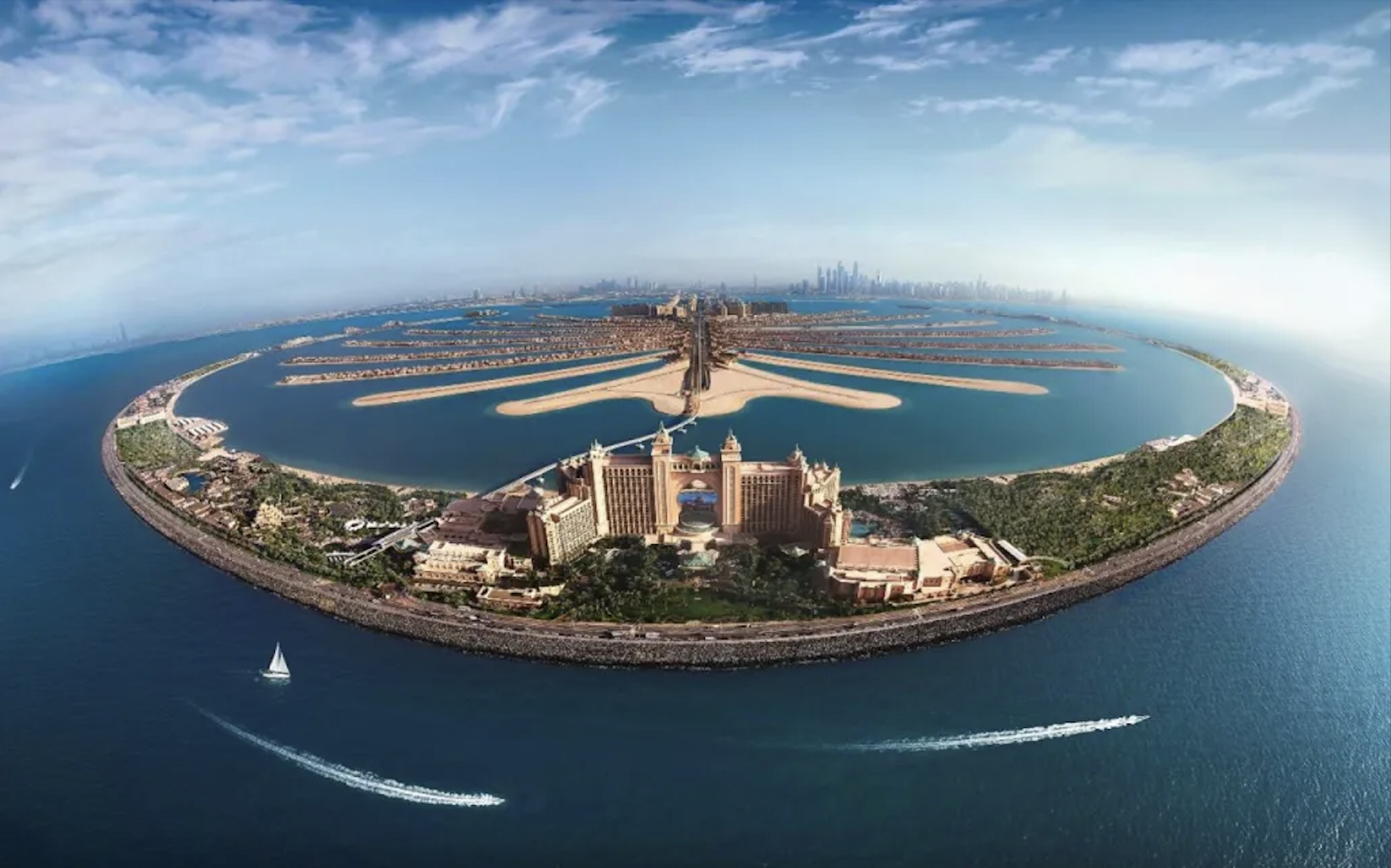 Aerial sunset view of Palm Jumeirah showing its iconic palm-shaped coastline